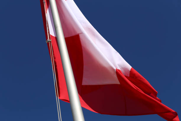 istock Swiss Flag with Blue Sky in the Background 1367153100