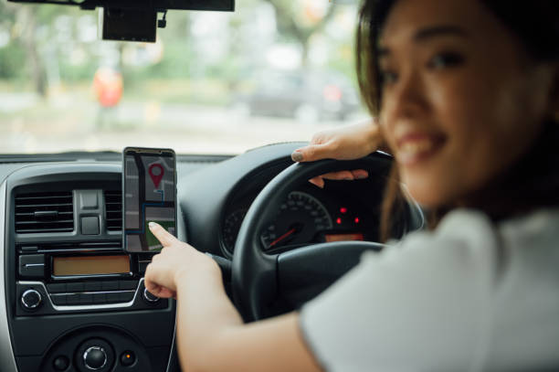 istock An Asian female driver using GPS navigation in mobile phone while driving car 1367153402