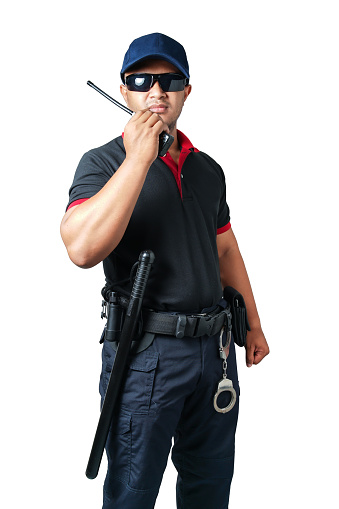 security guard wears dark glasses and wears a hat.holding a walkie-talkie with rubber batons ready and handcuffs on a tactical belt on a isolated white background Eliminate the concept of security
