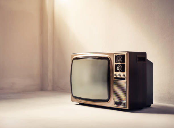istock Old retro TV in an empty white room. Village filter effect 1367154815
