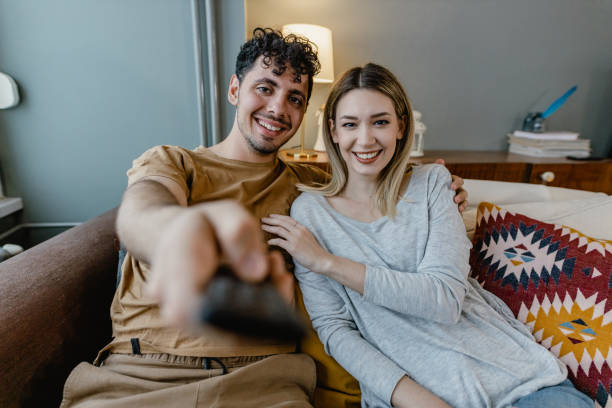 istock Couple watching TV at home 1367155245