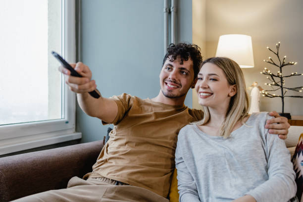 istock Couple watching TV at home 1367155554