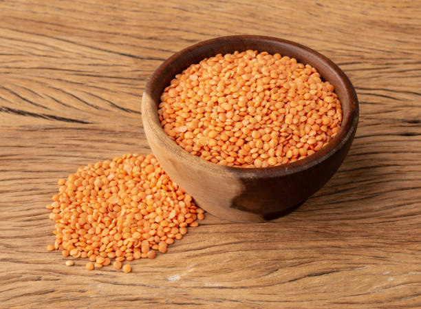 istock Orange lentil in a bowl over wooden table 1367156552