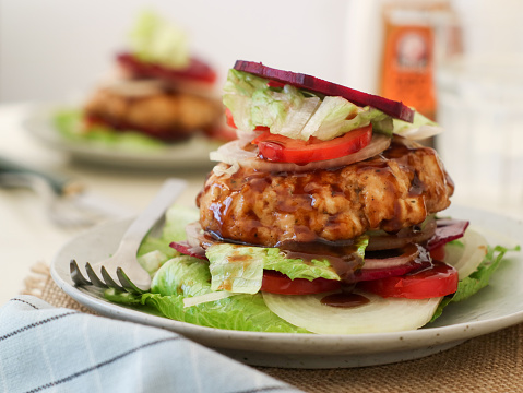 Low-carb bunless burger with green salad ,lean chicken breast wrap with variety of vegetable, tomatoes, onion which is alternative for those on ketogenic or paleo diet, top with sliced fresh beetroot