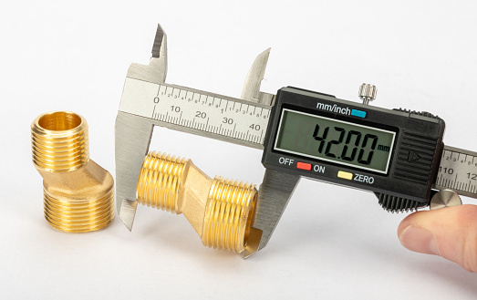 Measuring a brass eccentric tap reducer with a digital Vernier calliper