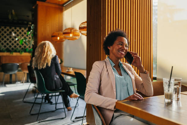 istock Businesswoman using a smartphone at cafe 1367158055