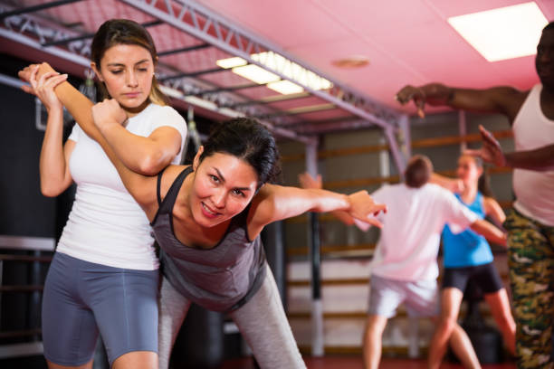 istock Two woman is training on self defense course in gym 1367158119