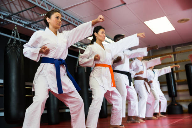 istock Adult people practicing taekwondo and warming up for training while standing barefoot 1367158131