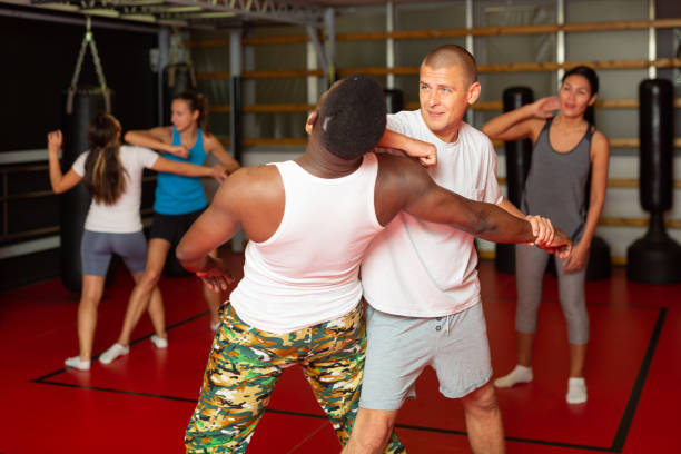 istock Men and women exercising during self-protection training 1367158183