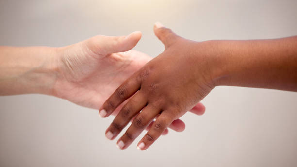 istock Shot of two people reaching for one another 1367159064