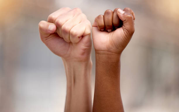 istock Shot of two people protesting together in solidarity 1367159066
