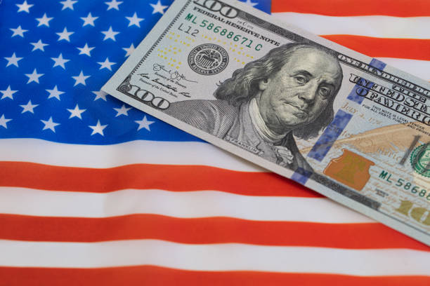 istock U.S. 100 dollar banknote on american flag background 1367159312