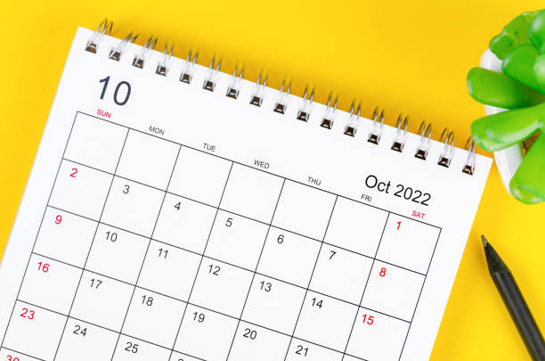 istock October 2022 desk calendar on yellow background. 1367161238