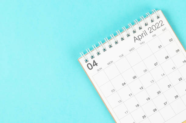 istock April 2022 desk calendar on blue background with empty space. 1367161256