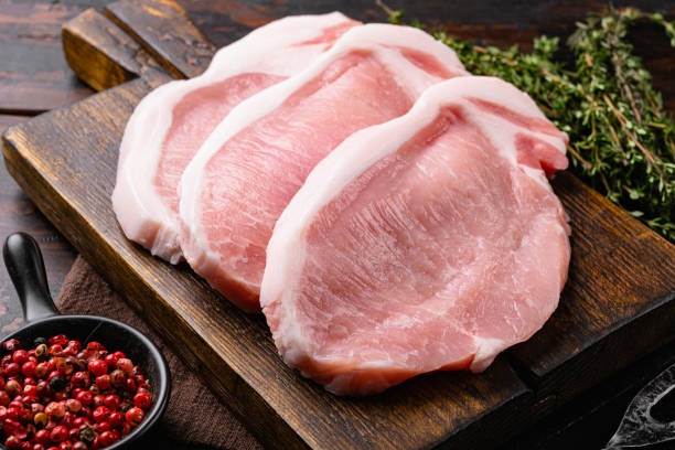 fresh pork with ingredients for cooking, on old dark  wooden table background - pork imagens e fotografias de stock