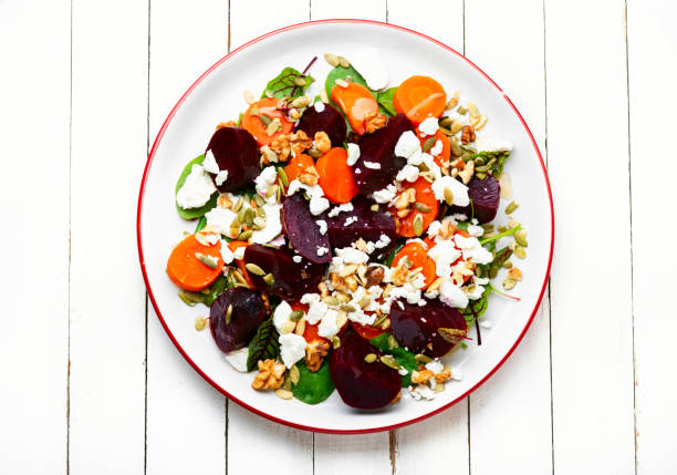 Diet salad with beetroot, carrots, cottage cheese, spinach and nuts.