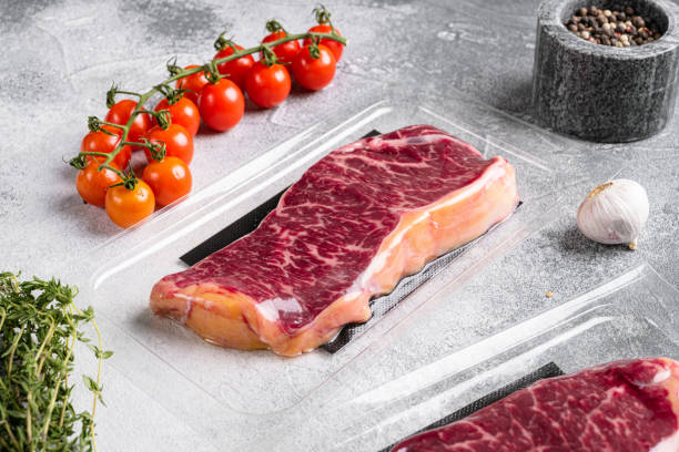 istock New York steak in vacuum pack, on gray stone table background 1367162560