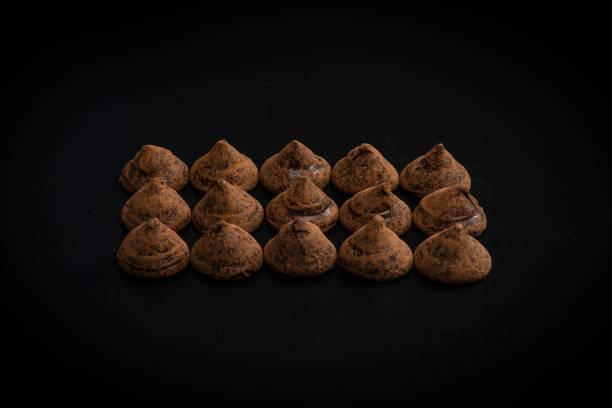istock Chocolate truffles on a black background. 1367162725