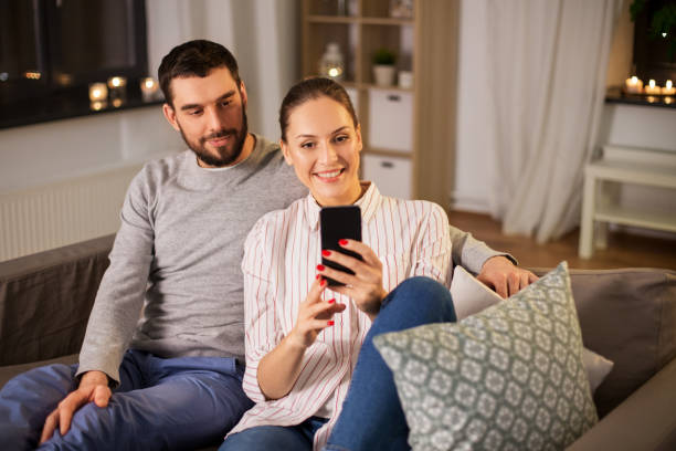 istock happy couple with smartphone taking selfie at home 1367163982