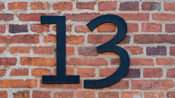 istock House number thirteen 13 on a red brick wall. High resolution photo. 1367164188