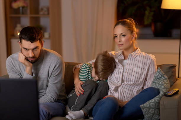 istock family watching something boring on tv at night 1367165535