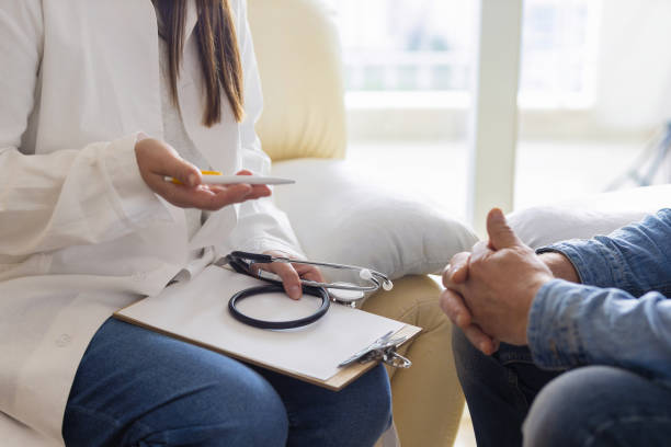 istock Female doctor explaining male patient while sitting in office 1367167523