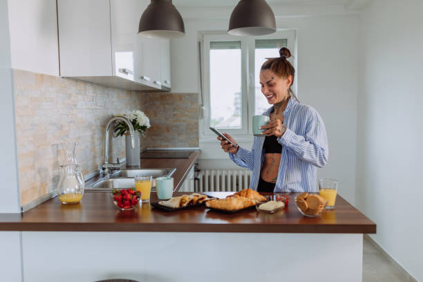 istock Woman using smartphone at home in the lounge 1367168905