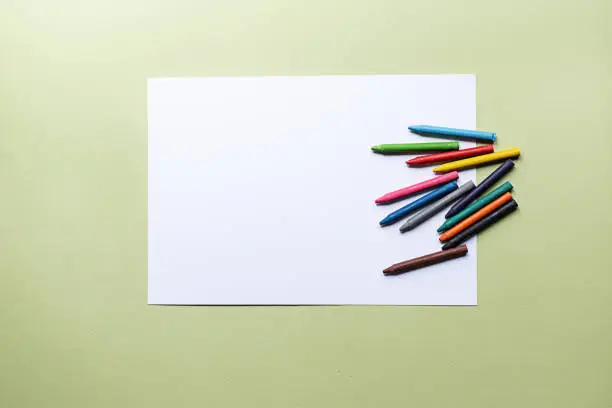 Photo of colorful crayons and blank paper