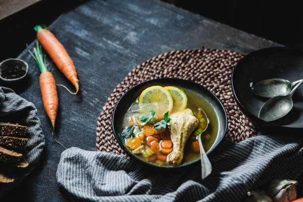 istock Bowl of chicken broth with vegetables on kitchen counter 1367170968