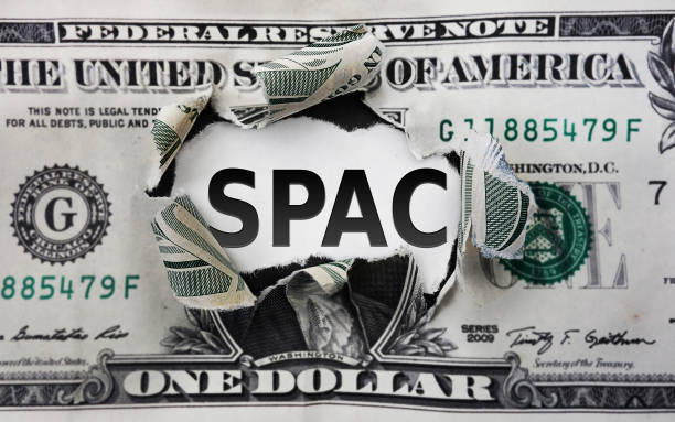 SPAC - Special Purpose Acquisition Company -- text on a torn dollar bill stock photo