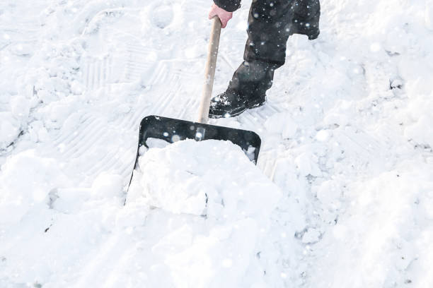 istock A man clears snow with a shovel after a snowfall. Snow removal. 1367176885
