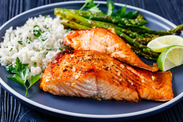 istock fried salmon fish fillet with rice and asparagus 1367180821