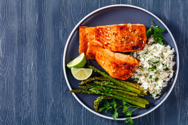 istock fried salmon fish fillet with rice and asparagus 1367180895