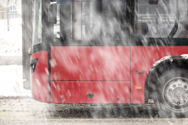 autobús de transporte público en calles nevadas en condiciones invernales. - public transportation winter bus front view fotografías e imágenes de stock