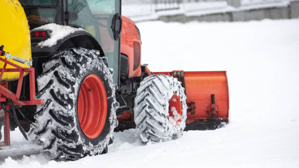 istock Tractor cleaning urban park paths on a cold snowy day. 1367182598
