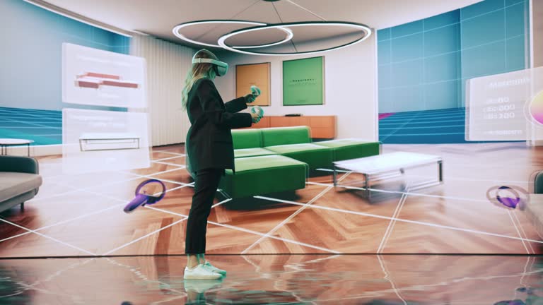 Interior Designer Using a VR Software to Design a Home, Try Different Colors, Move Furniture in Interactive Environment. Female Engineer Using Virtual Reality Headset and Controllers for Her Project.