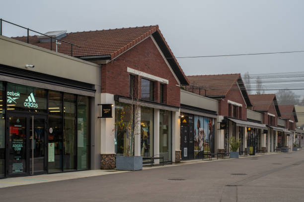 Romainville cityscape Romainville, France - January 13 2022: Adidas and Reebok outlet store in Paddock Paris EST Factory Outlet village near Paris on a cloudy winter morning. reebok stock pictures, royalty-free photos & images