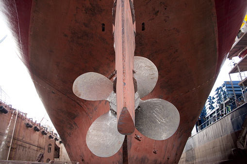 Ship's rudder and propeller view when dry docking in the shipyard.