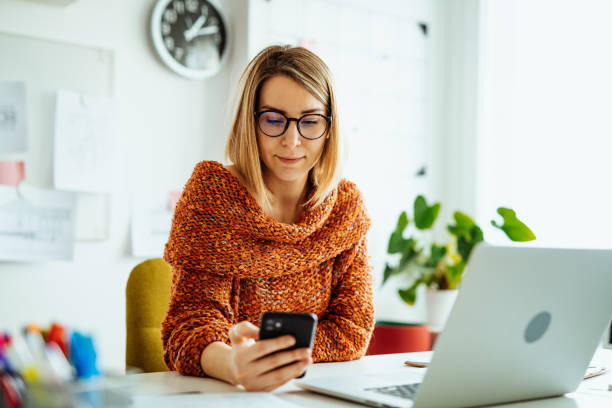 istock Businesswoman working from home and using smart phone for online payments 1367187062
