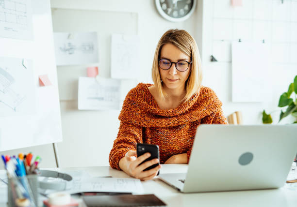 istock Businesswoman working from home and using smart phone for online payments 1367187083