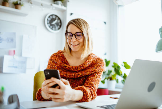istock Businesswoman working from home and using smart phone for online payments 1367187099