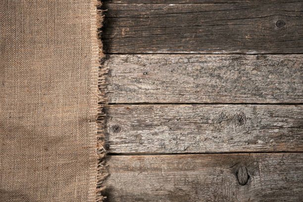 istock Background with old wooden boards covered with burlap cloth 1367187465