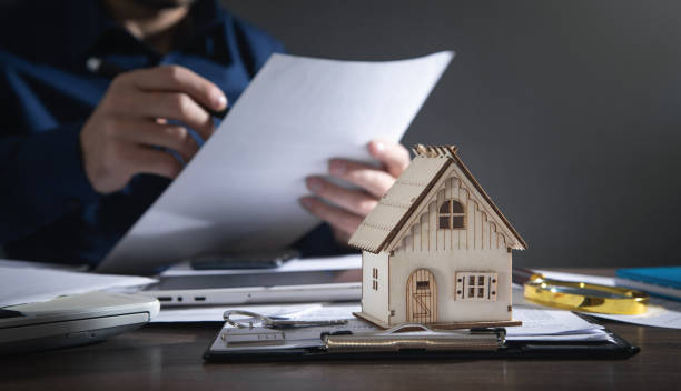 istock Real estate agent signing document for home loan insurance. 1367188197