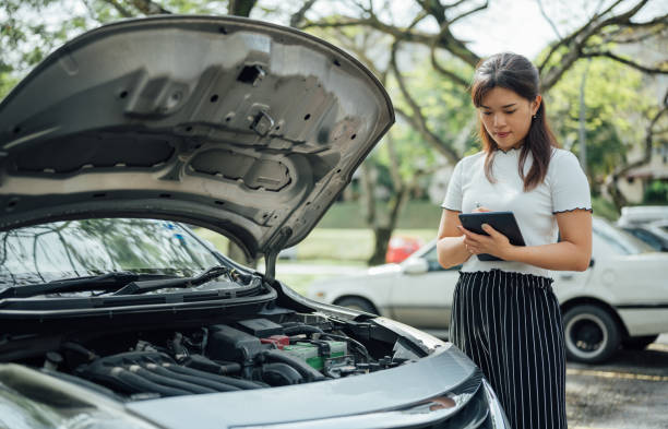 an asian insurance adjuster inspecting damage to vehicle - bilförsäkring bildbanksfoton och bilder