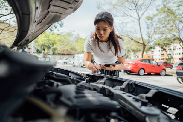 an asian insurance adjuster inspecting damage to vehicle - car insurance insurance agent damaged imagens e fotografias de stock