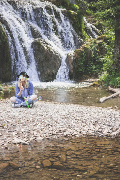 istock Woman enjoying spring making soap balloons 1367189801