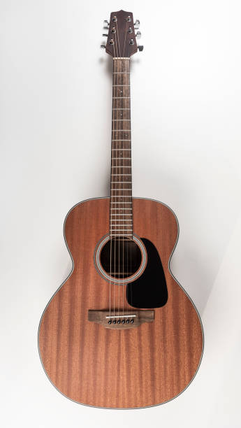 Traditional mahogany acoustic guitar stock photo