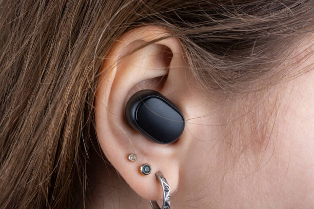 istock Wireless headphones in a girl's ear. 1367189977