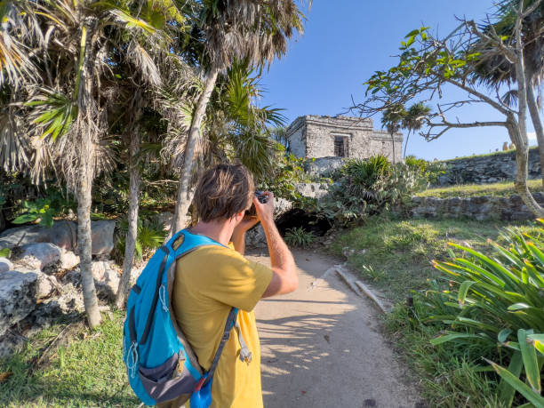 istock Young man photographing ancient temple in Mexico 1367191963