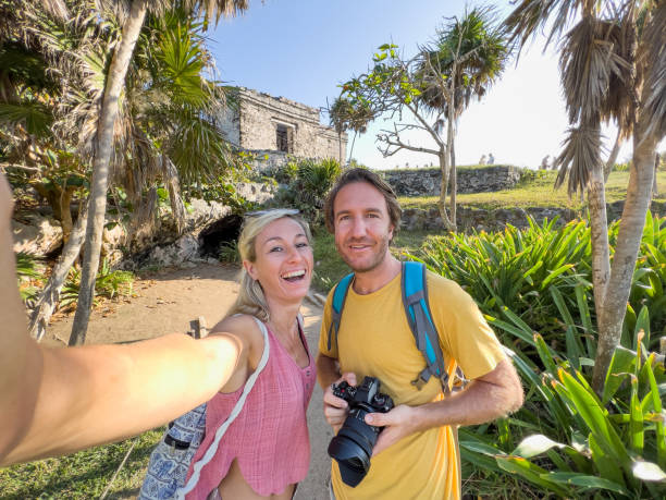 istock Couple take selfie with ancient temple in Mexico 1367191987
